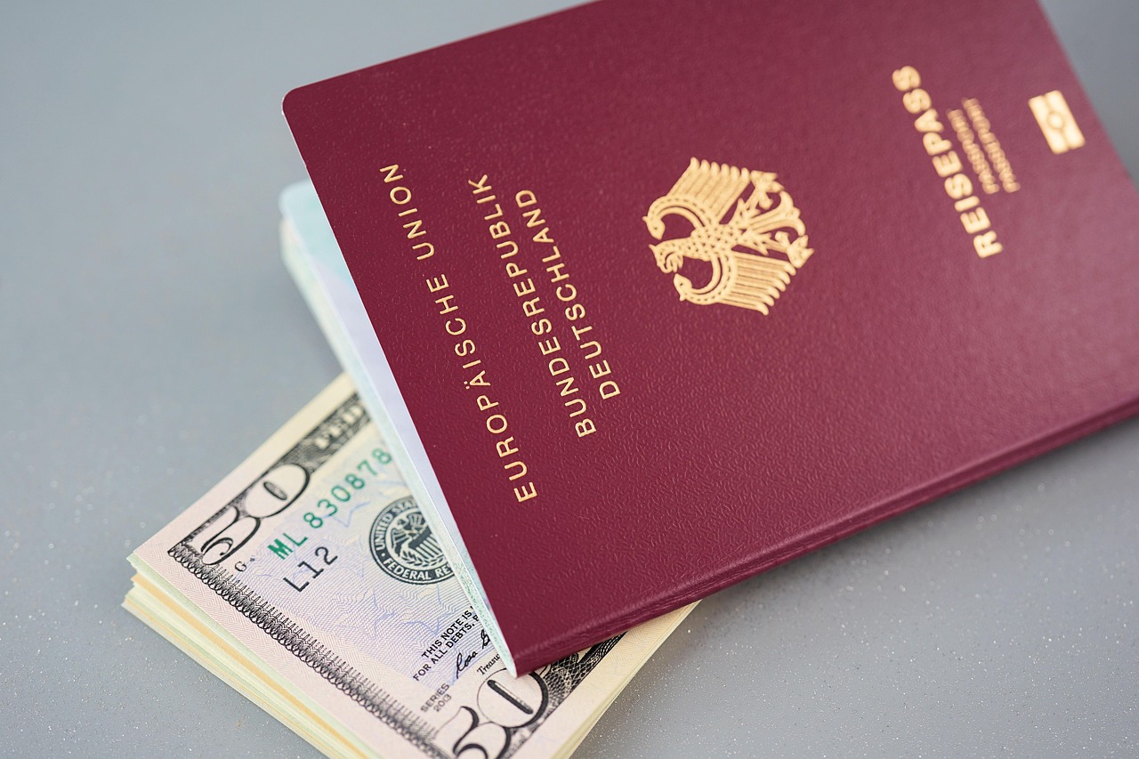 Canada eTA: a German passport resting on a stack of US fifty-dollar bills