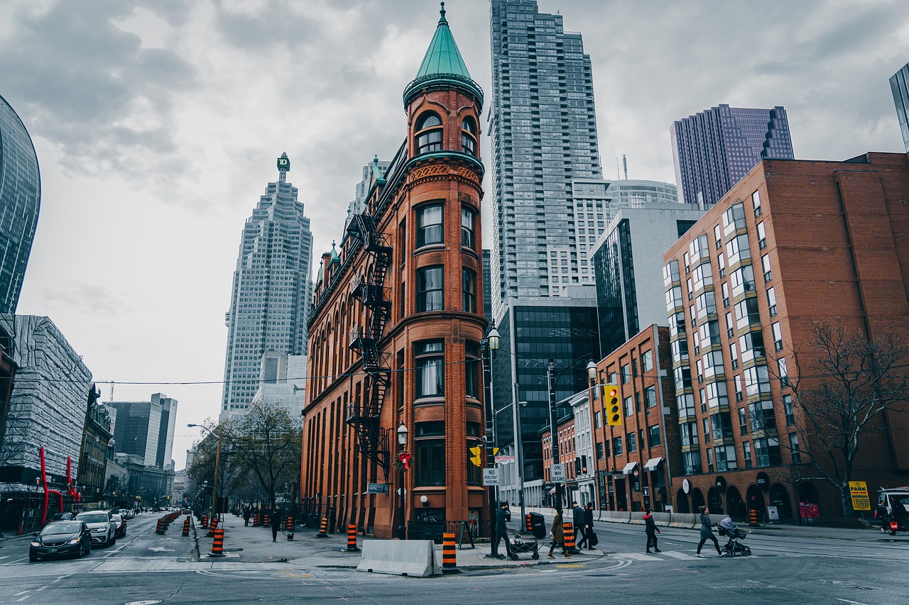 The historic Gooderham Building in downtown Toronto against a backdrop of modern skyscrapers.
