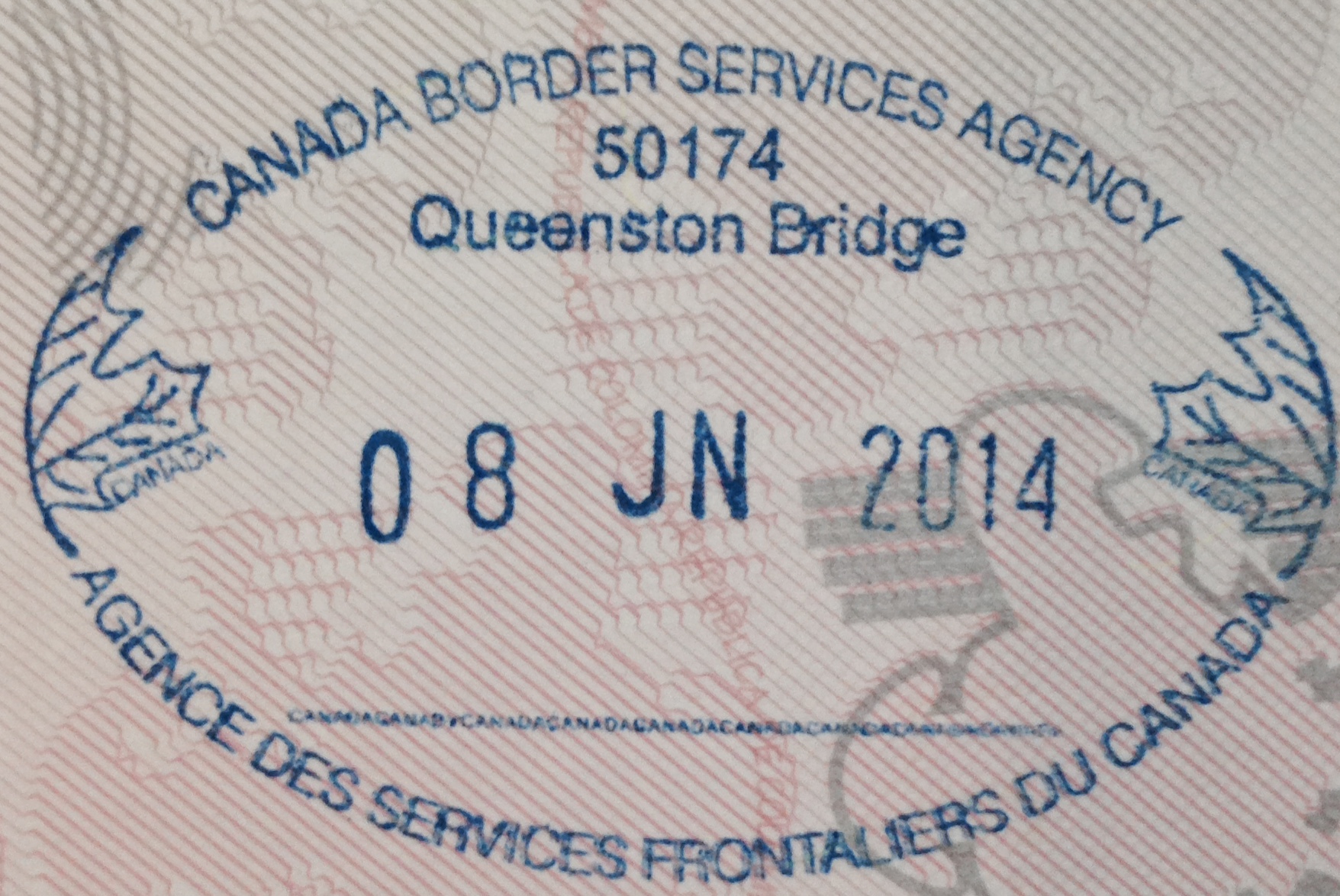 Close-up of a blue Canadian border entry stamp on a passport page, dated 08 JN 2014 at Queenston Bridge.