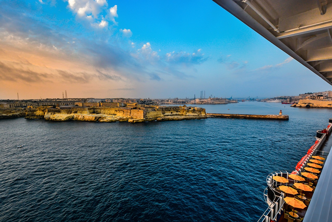 Do You Need a Canada eTA for a Cruise or Ferry? Entering Canada by Boat: view of a harbour and coastline at sunset from a cruise ship deck