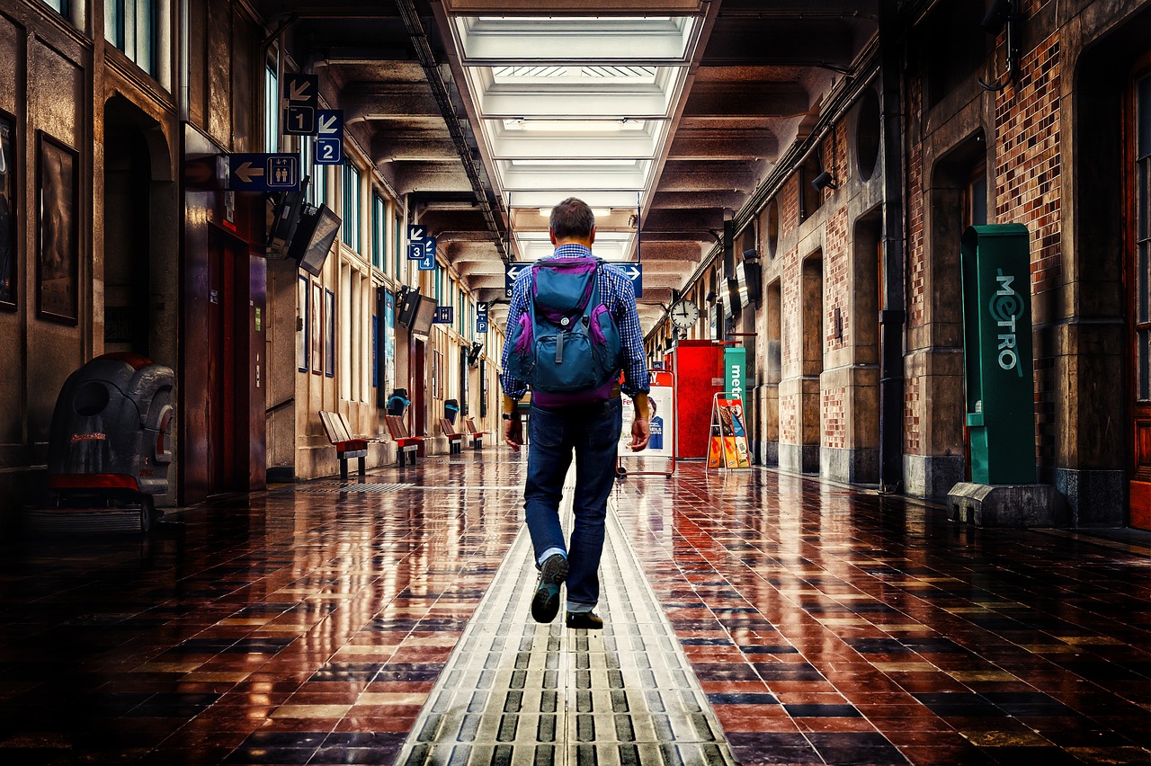 Canada eTA for French Citizens: Requirements, Cost and Passport Number: traveller with a backpack walking through an airport corridor