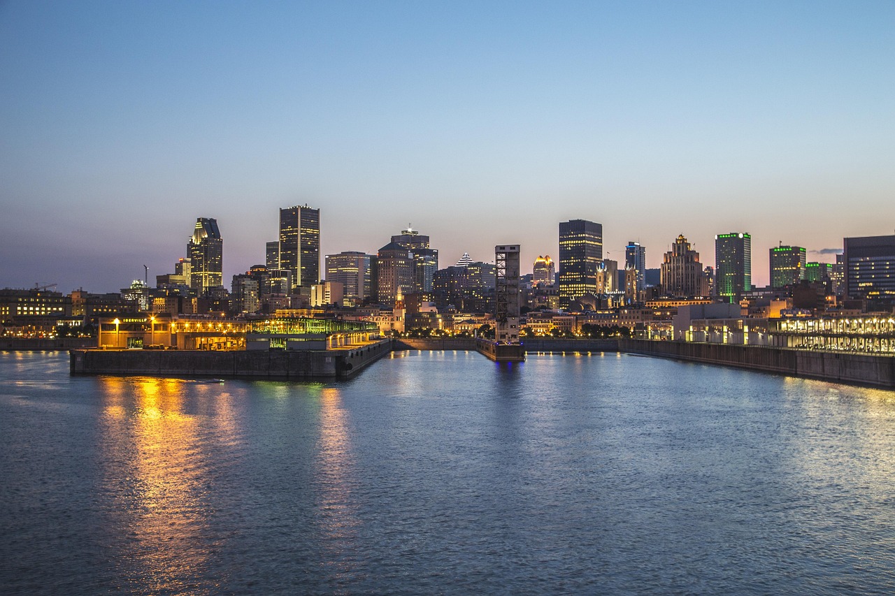 Arriving at Montreal-Trudeau airport with an eTA: the Montreal skyline and the Old Port lit up across the water at dusk